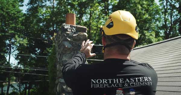 chimney-tech-inspecting-chimney---northeastern-masonry-&-chimney chimney tech inspecting chimney