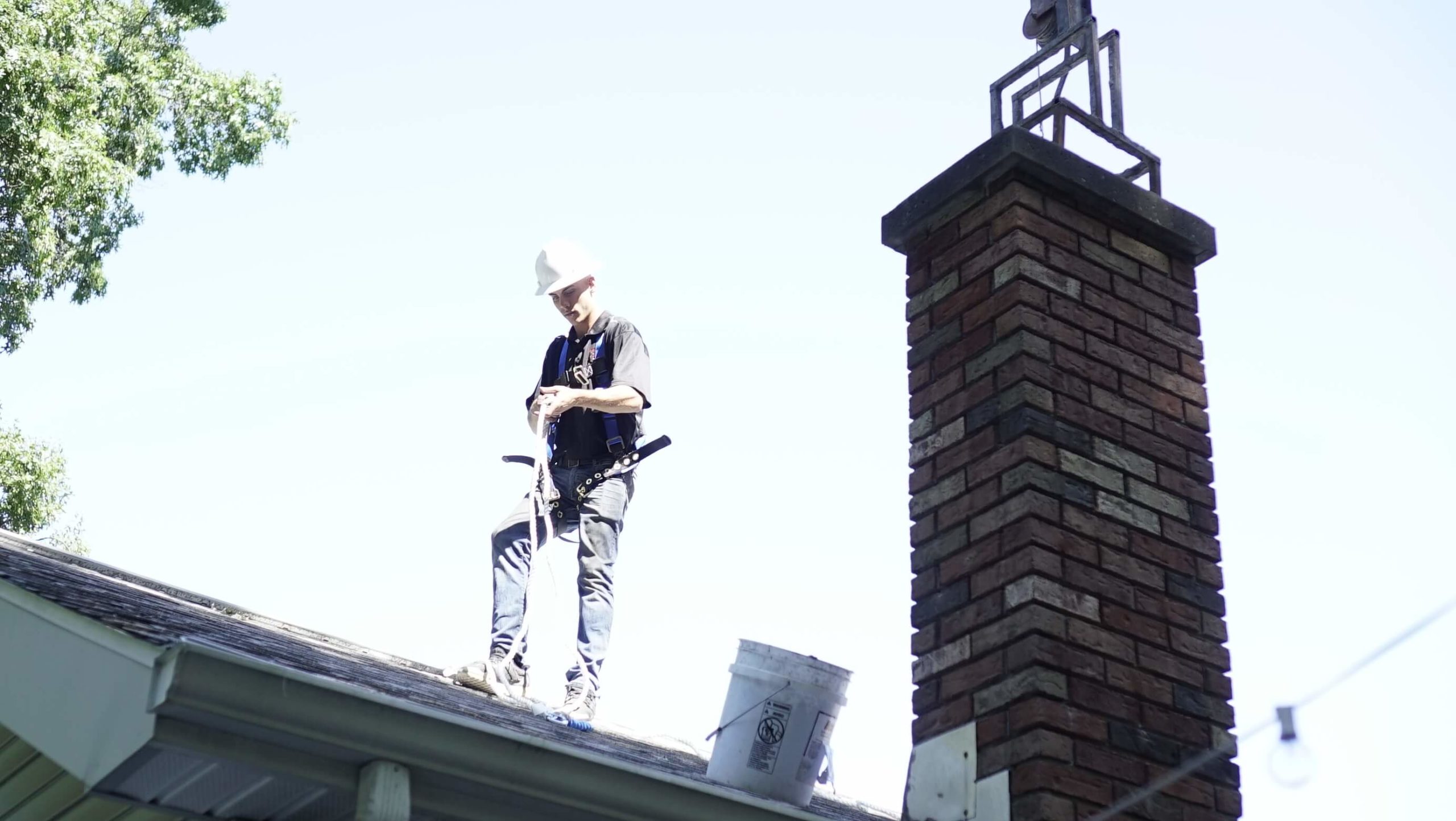 man on roof man on roof by chimney