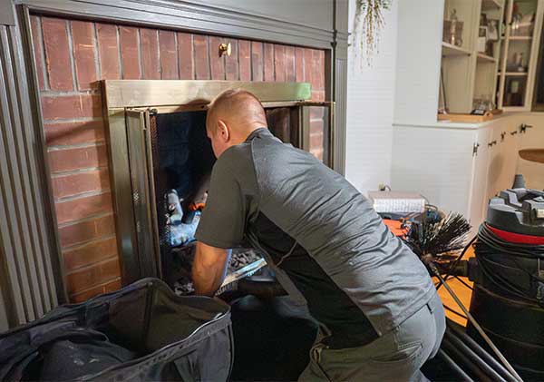 Northeastern Technician Sweeping Chimney