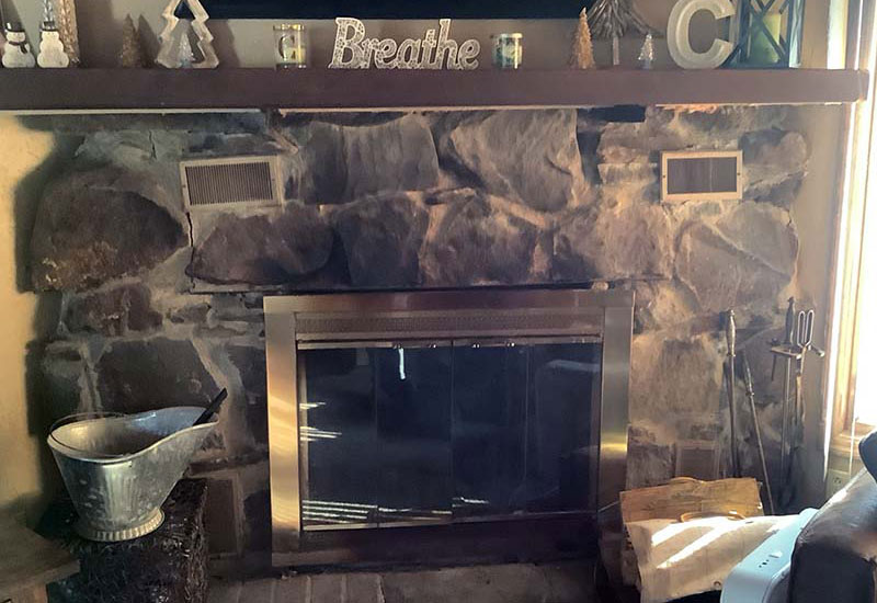 Before photo of a fireplace, total facelift, new cultured stone, hearth, and glass doors
